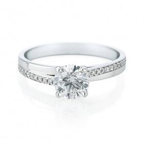 round brilliant cut diamond ring with offset side diamonds in white gold