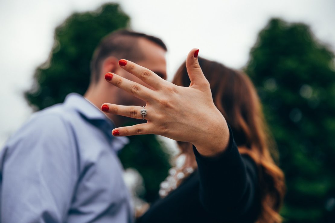 woman showing off her radiant cut diamond ring