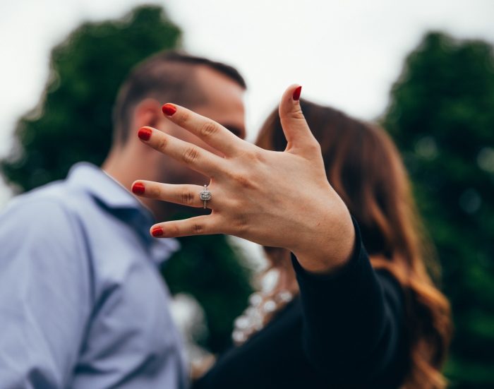 woman showing off her radiant cut diamond ring