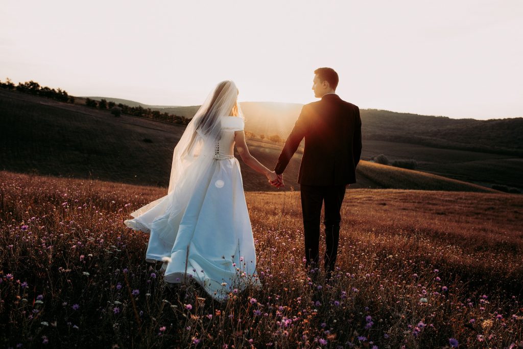 bride and groom walking in the sunset