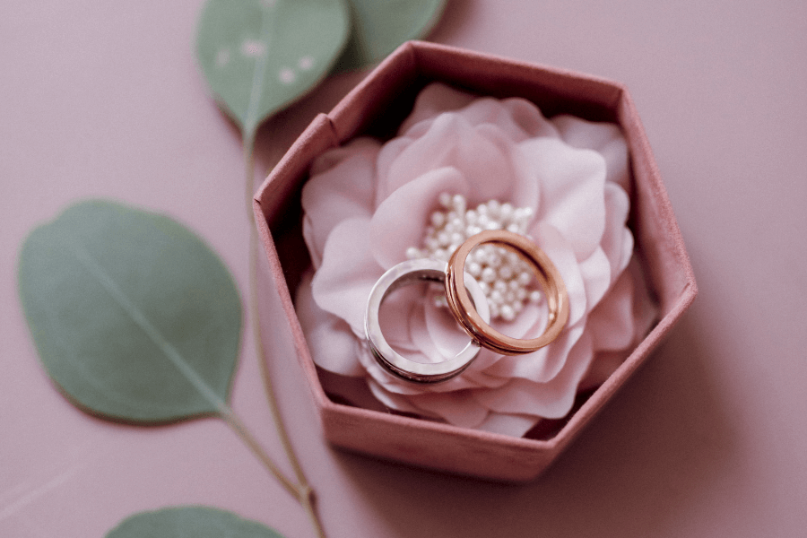 Couple rings in a pink color hexagon shaped box Couple rings in a pink color hexagon shaped box