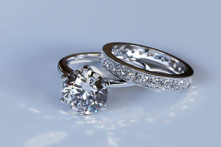 White gold solitaire diamond engagement ring and eternity wedding band with round brilliant cut diamonds.